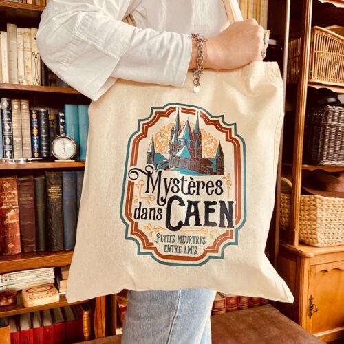Le totebag mystères dans Caen, en vente sur notre boutique en ligne, fait partie de la collection Mystères Caen, qui comprend également un pack de visite insolite de la ville de Caen.